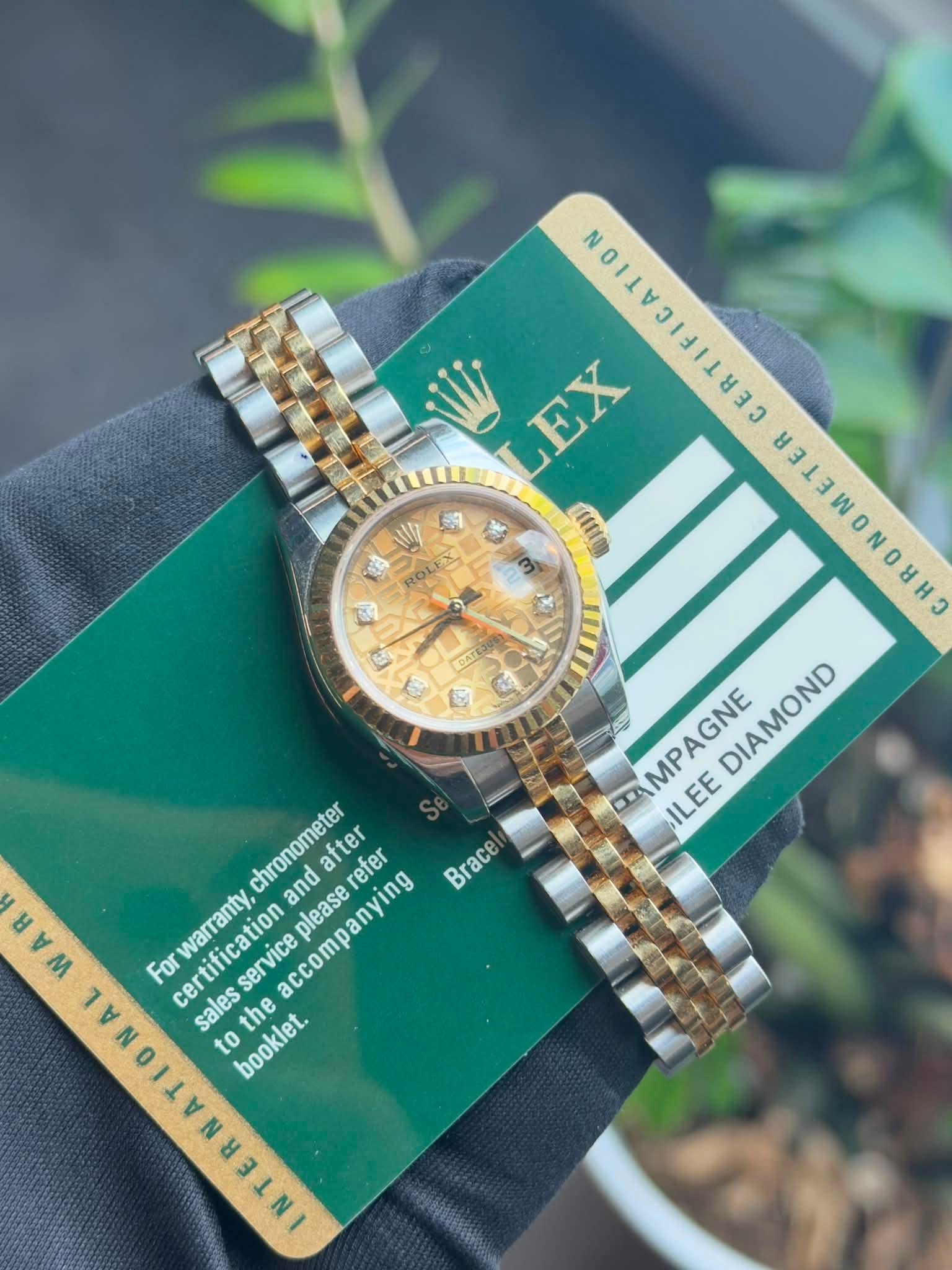 May be an image of wrist watch and text that says 'ROLEX ROLES E GATE LEX 11 ្វ က က 8313 AGNE DIAMOND D AMPAGNE MP ILEE chronometer and please after refer Brace ㅂ M warranty,…