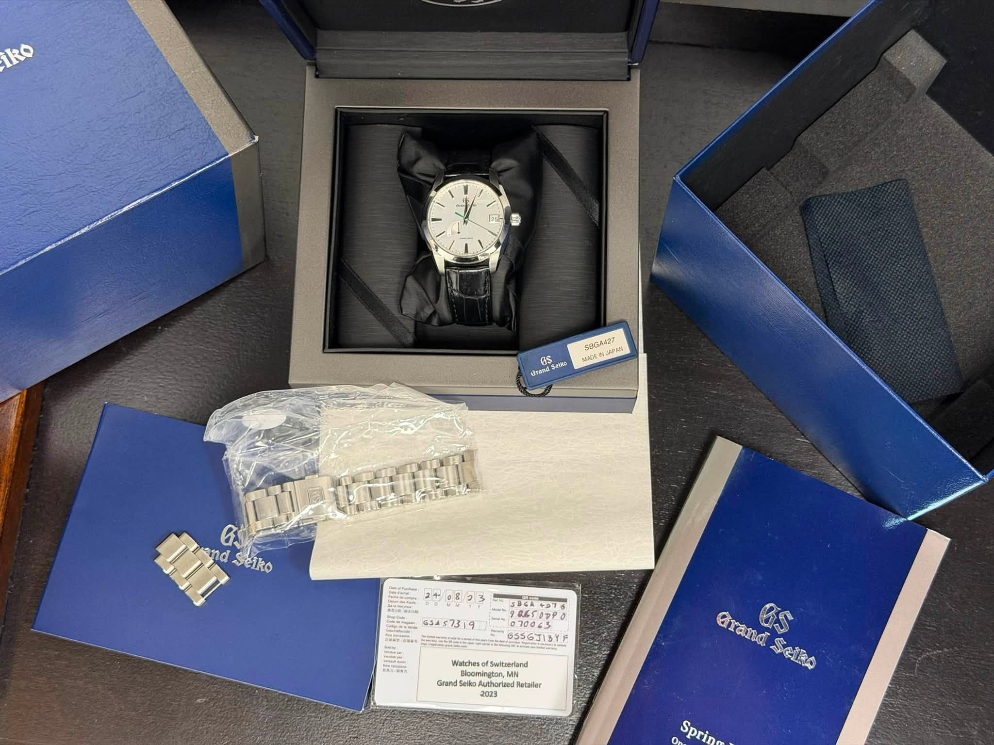 May be an image of wrist watch, cufflinks and text