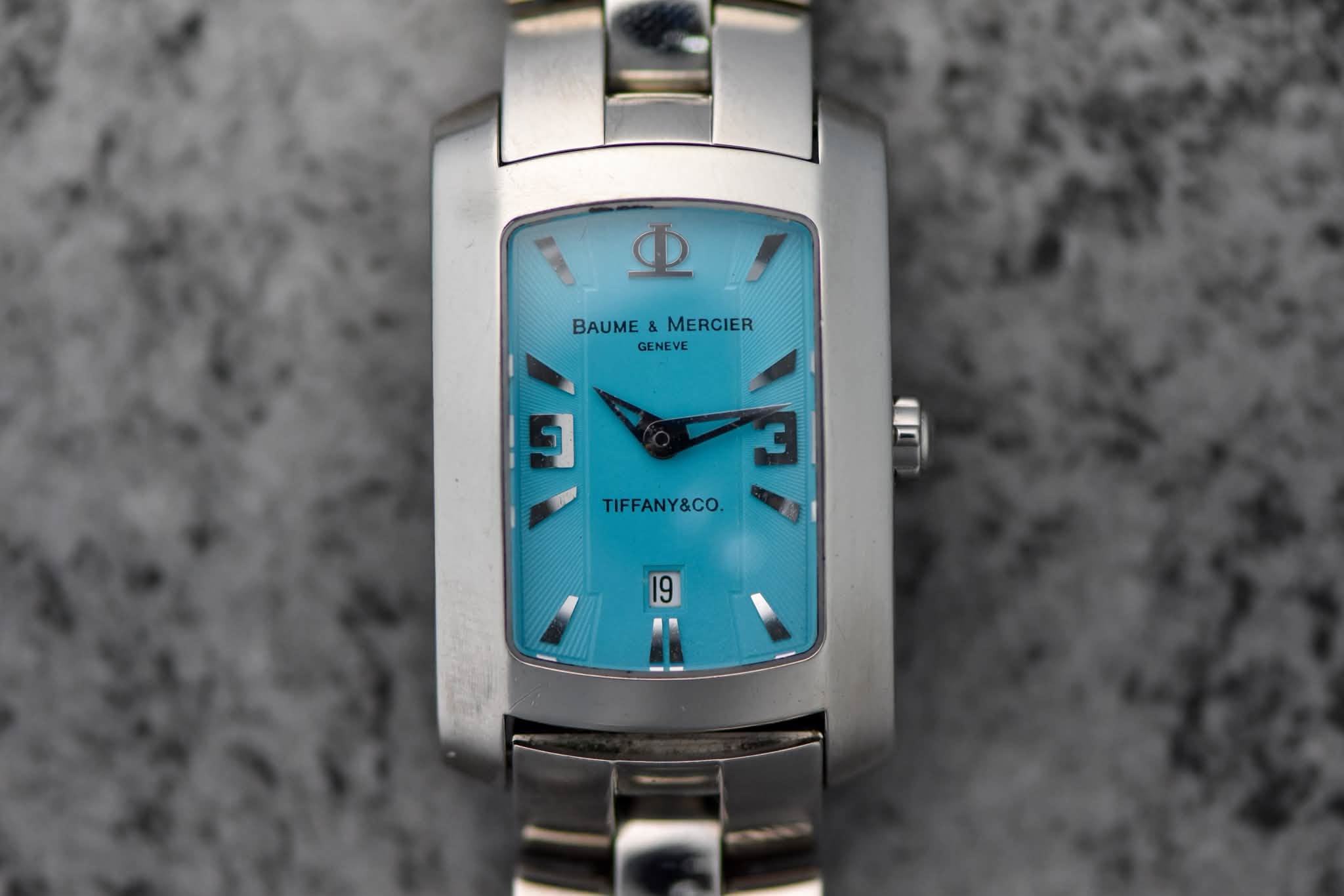 May be an image of wrist watch and text that says 'μΈ BAUME BAUME&MERCIER & MERCIER GENEVE 9 C TIFFANY&CO.'