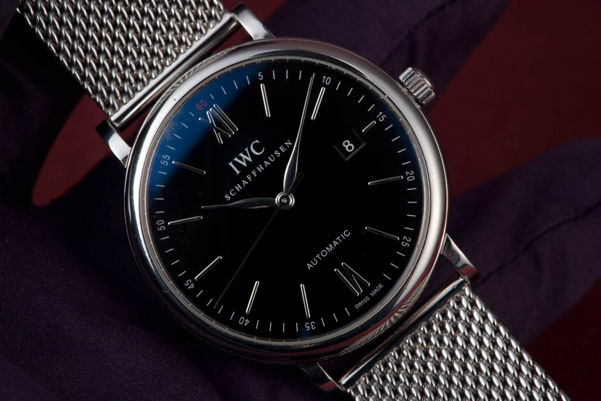 May be an image of wrist watch and text that says 'uin IWC WC 20 AUTOMATIC'