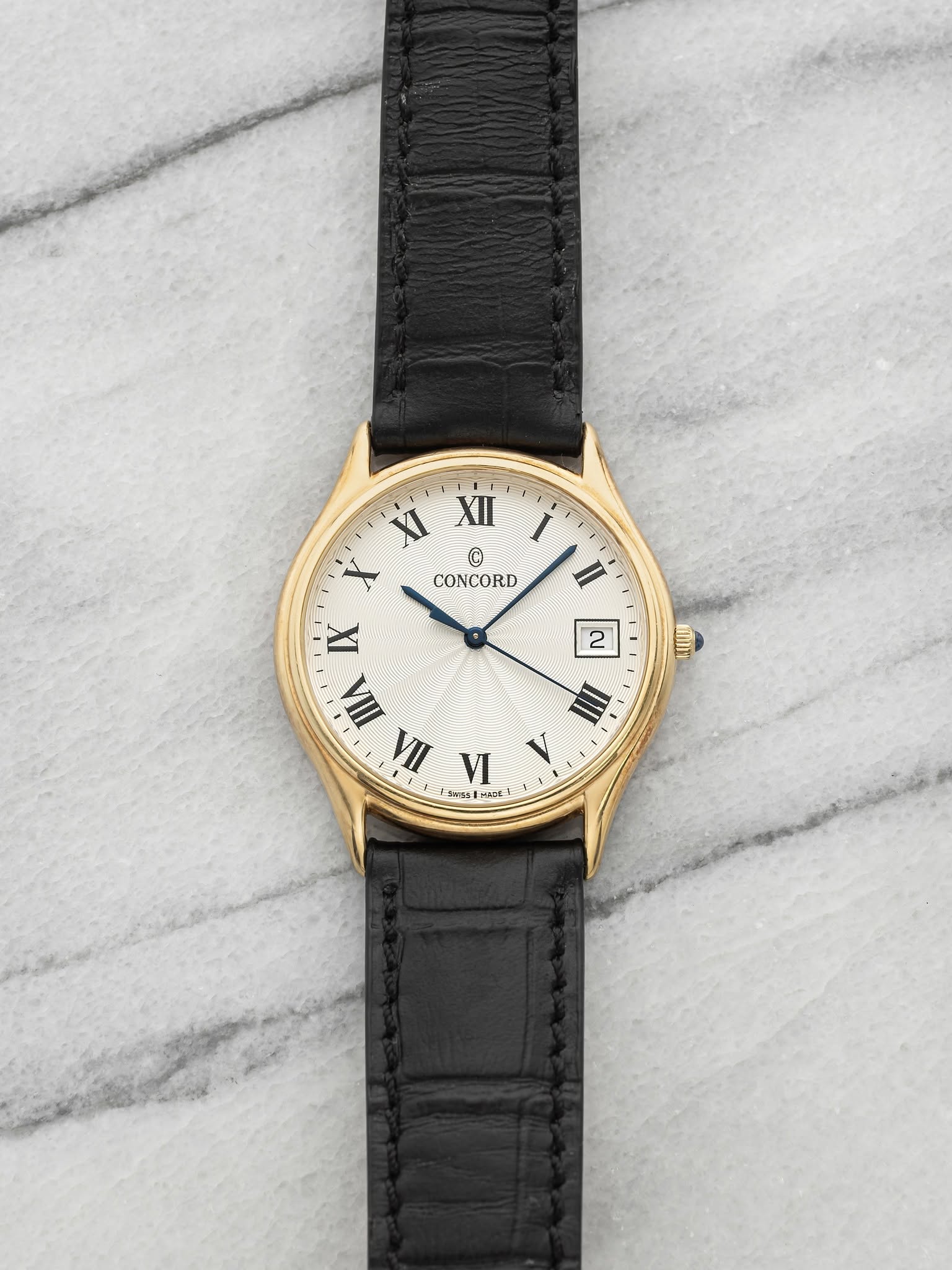 May be an image of wrist watch, leather and text