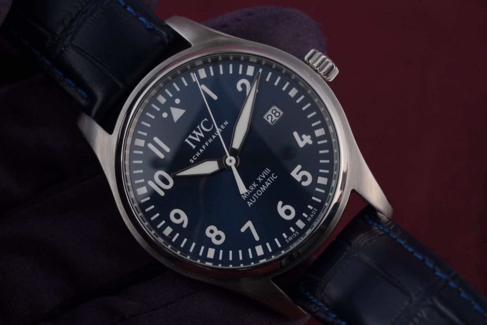 May be an image of wrist watch and text that says 'C IWC N S و 28 L AUTOMATIC 5 6 7 10 σ'
