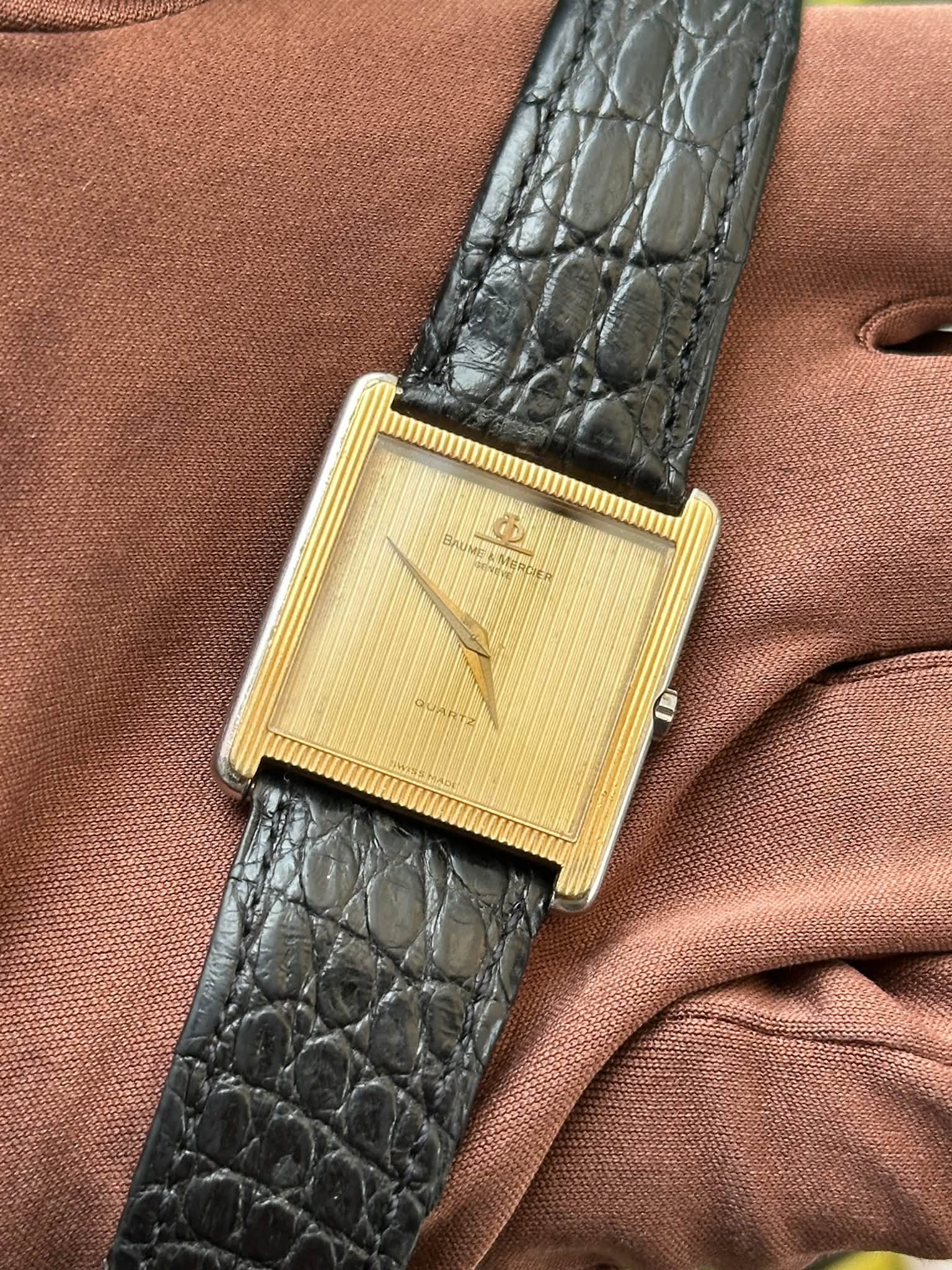 May be an image of leather, wrist watch and text
