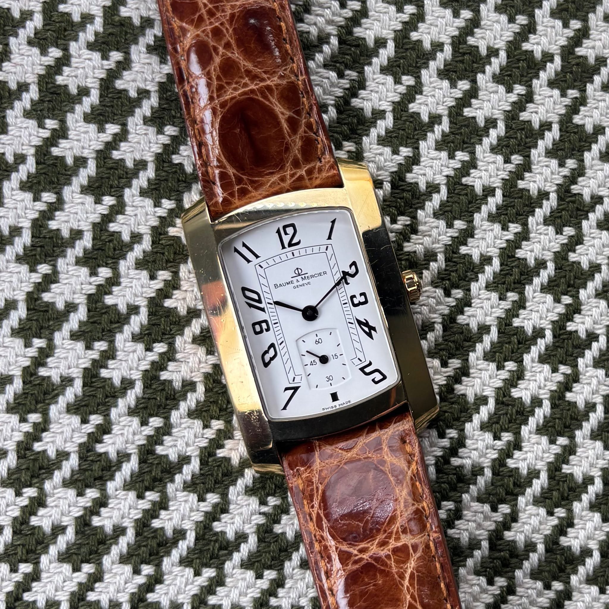 May be an image of saddle-stitched leather, wrist watch, leather and text