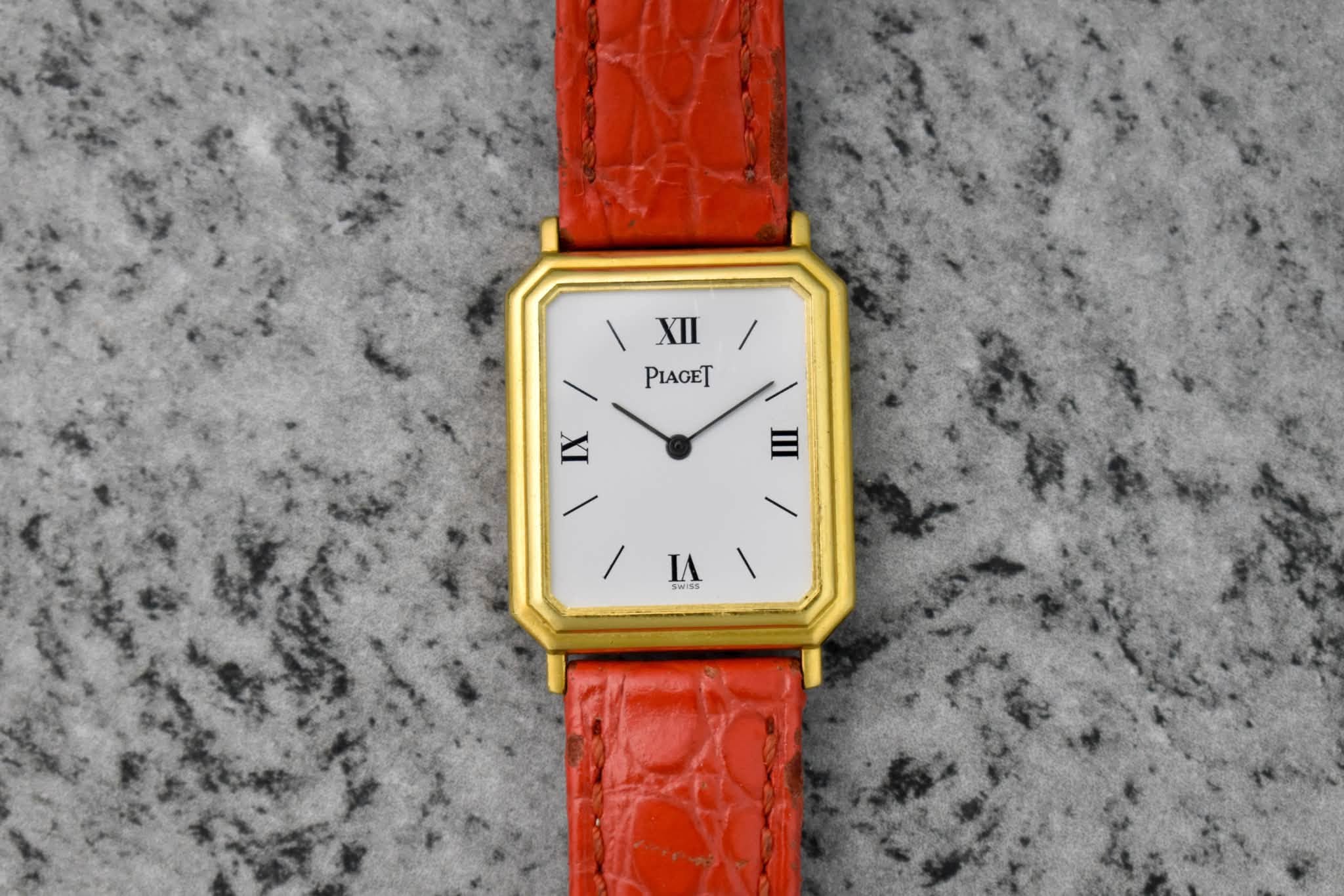 May be an image of wrist watch, leather and text