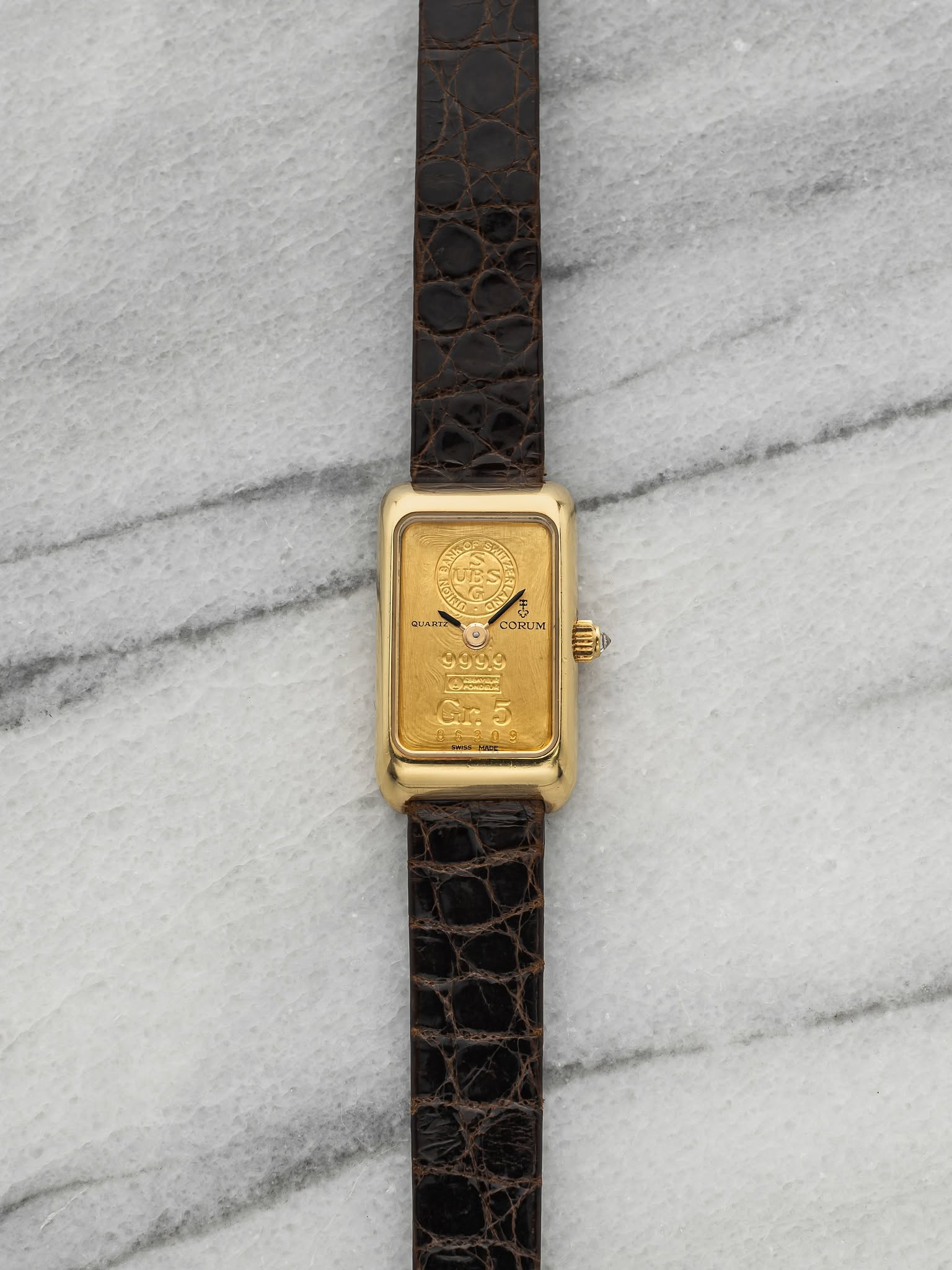 May be an image of wrist watch, leather and text