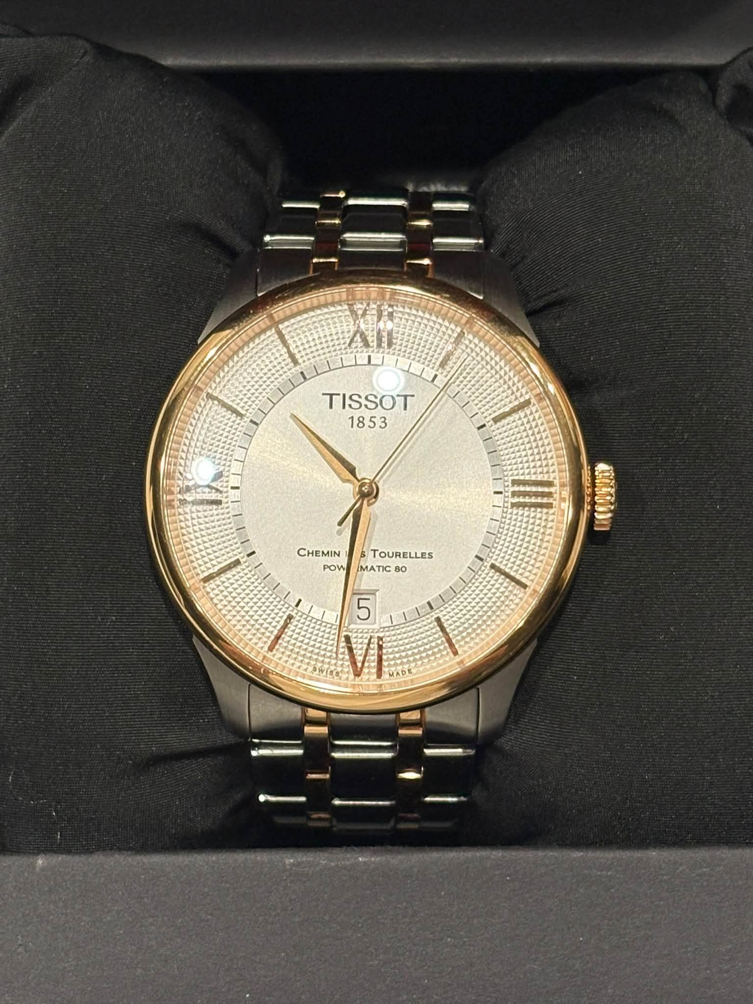 May be an image of wrist watch and text