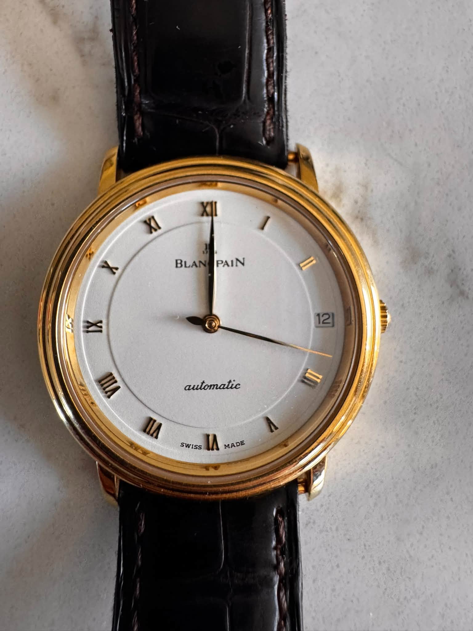 May be an image of wrist watch and text