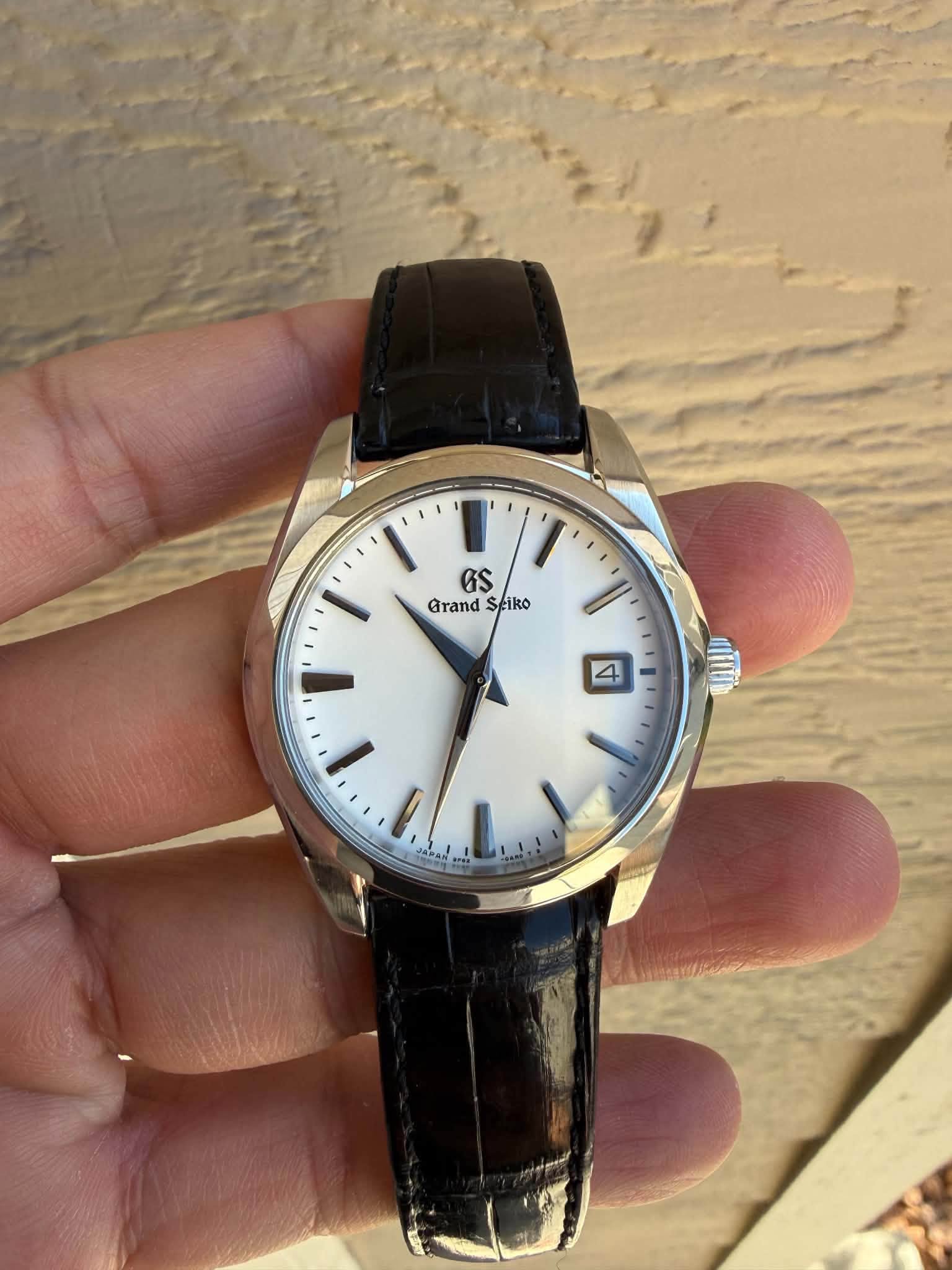 May be an image of wrist watch and text
