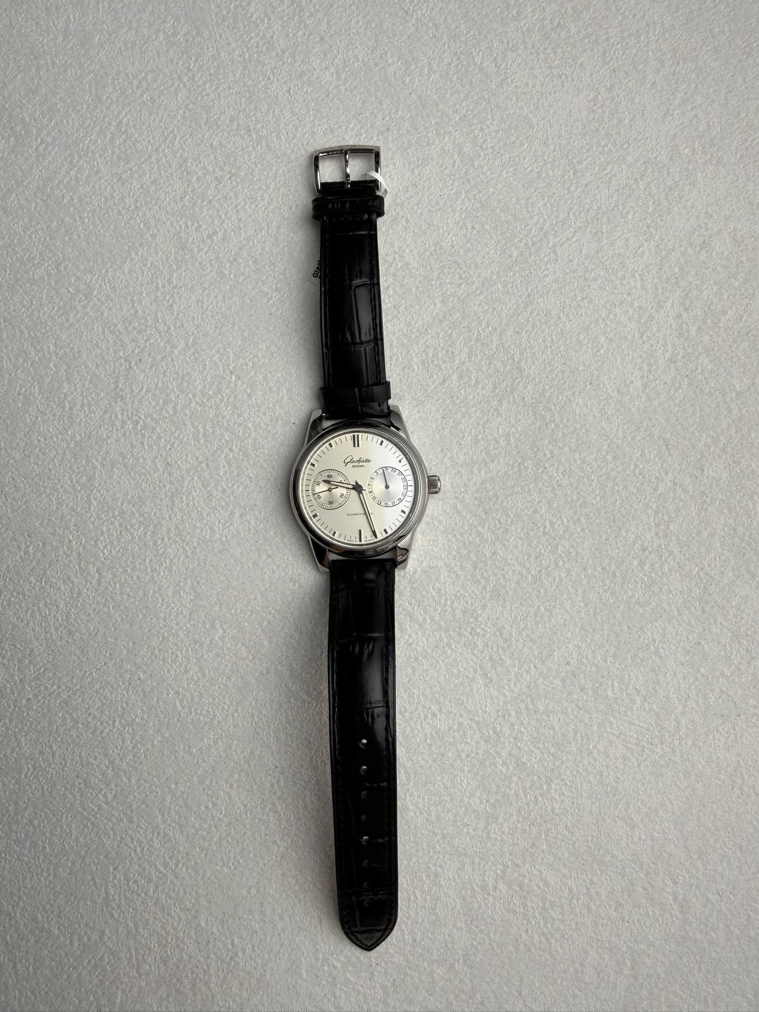May be an image of wrist watch and text
