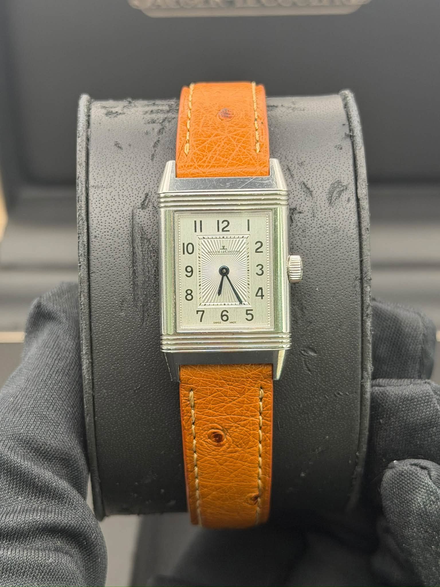 May be an image of wrist watch, leather and text