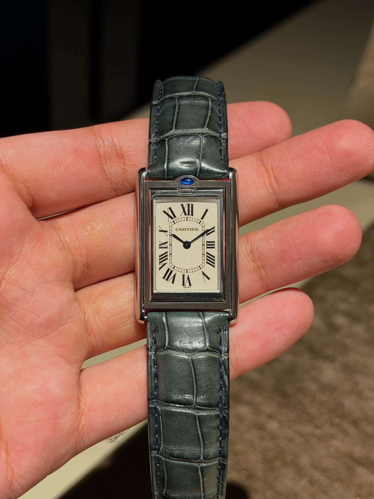 May be an image of wrist watch and text