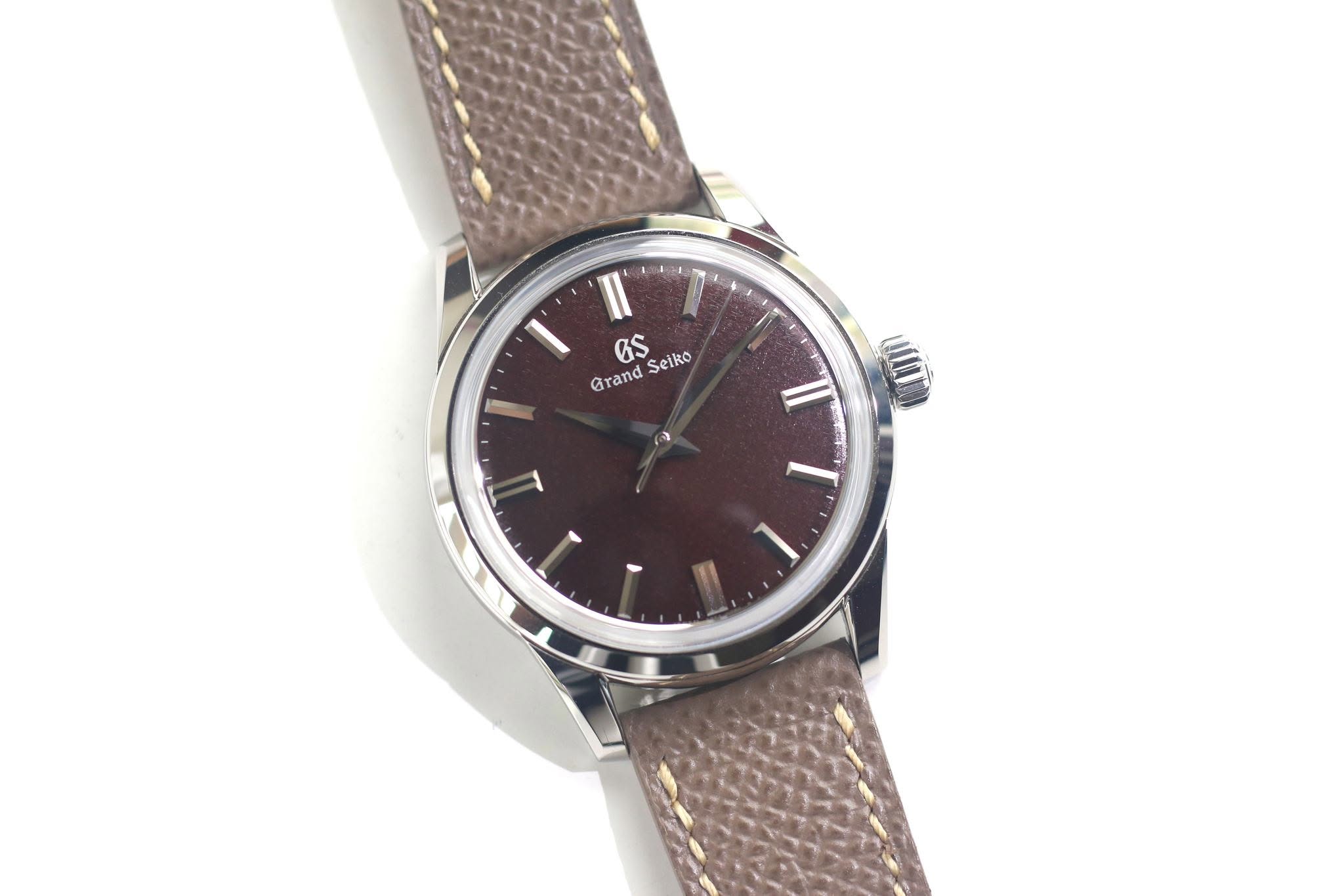 May be an image of wrist watch, leather and text