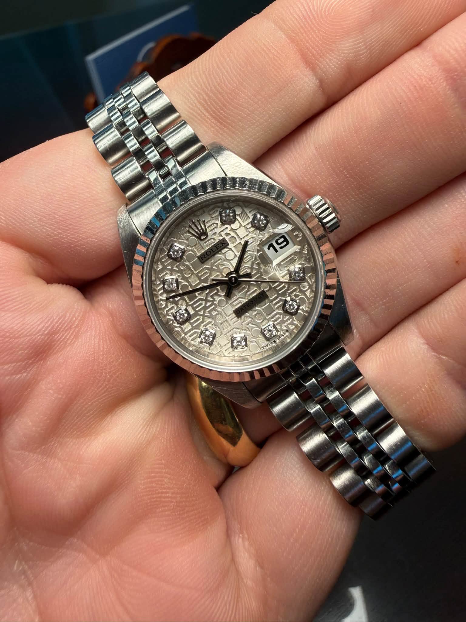 May be an image of wrist watch and text