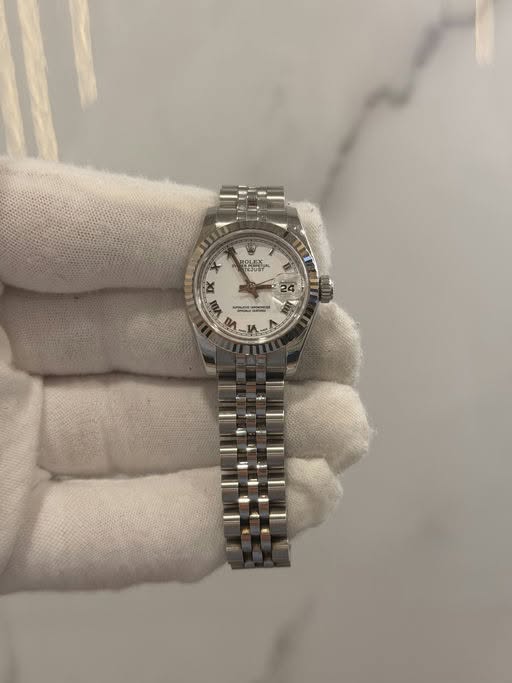 May be an image of wrist watch and text