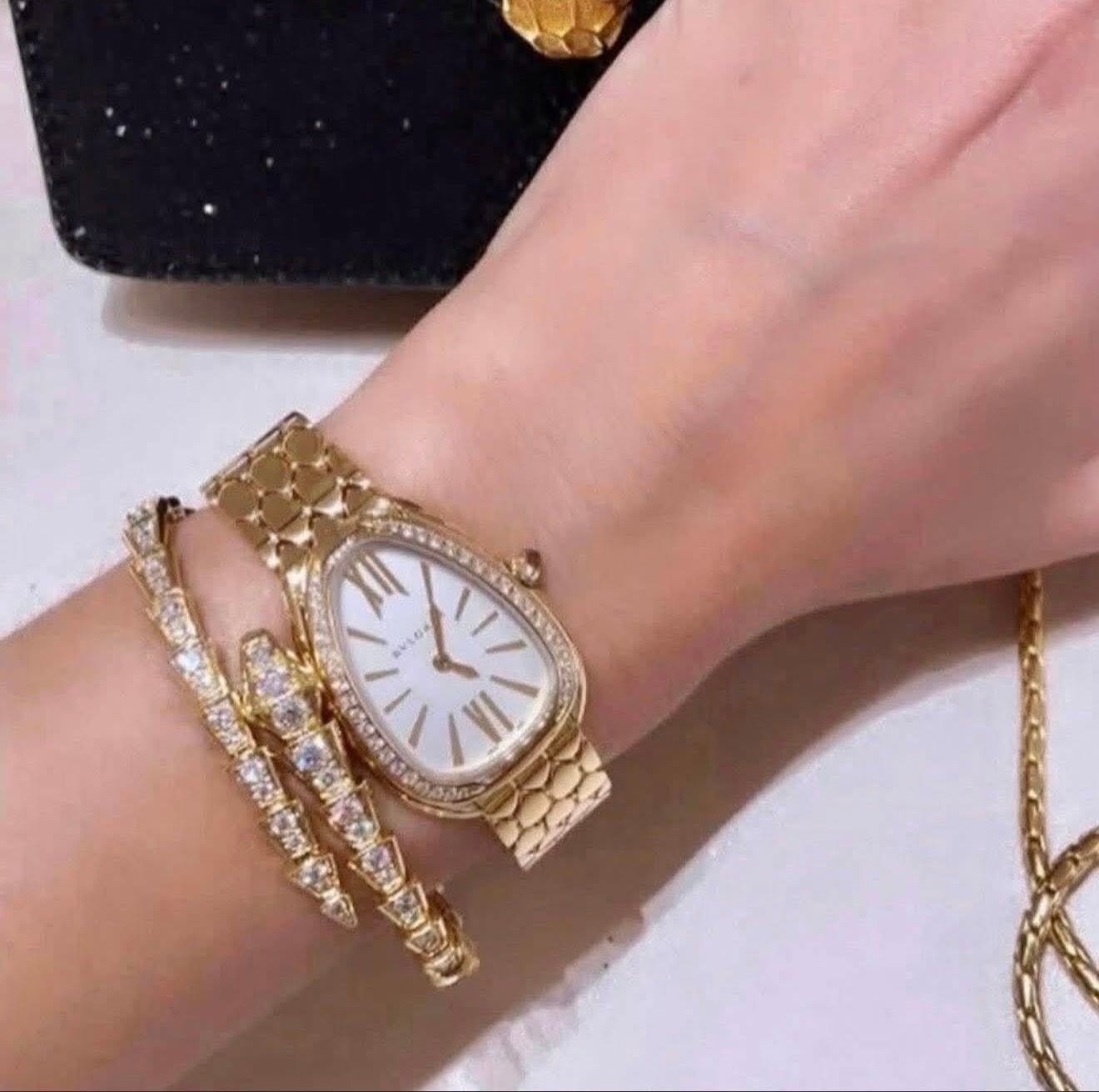 May be an image of wrist watch, jewelry and text