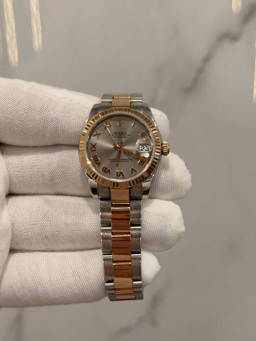May be an image of wrist watch and text