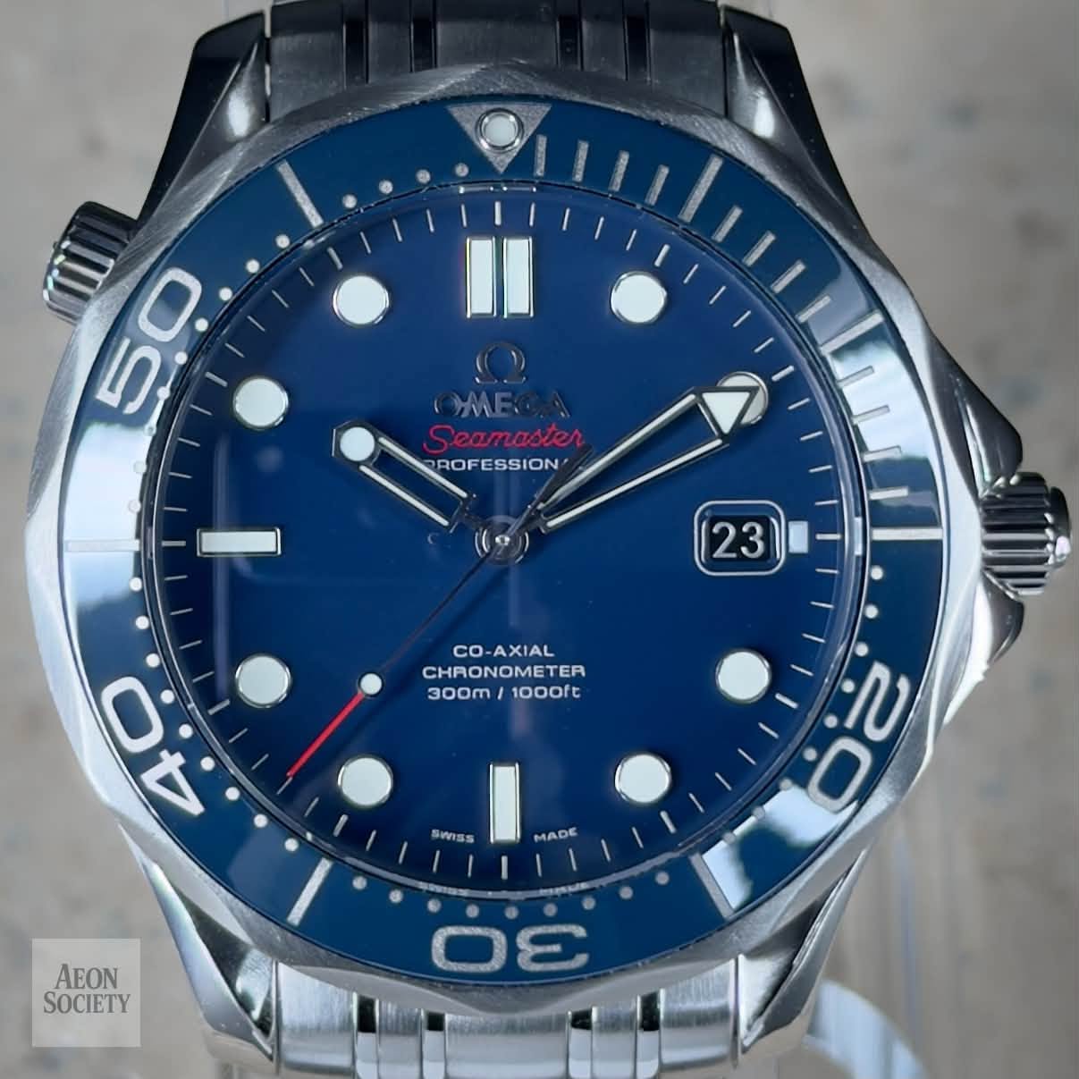 May be an image of wrist watch and text that says '50 5 ROFESSION ROF 23 CO-AXIAL XIAL co CHRO CHRONOMETER METER TER 300m 1000ft ب 4.0 4 Swiss MADE נן. O AEON SOCIETY MS DE'
