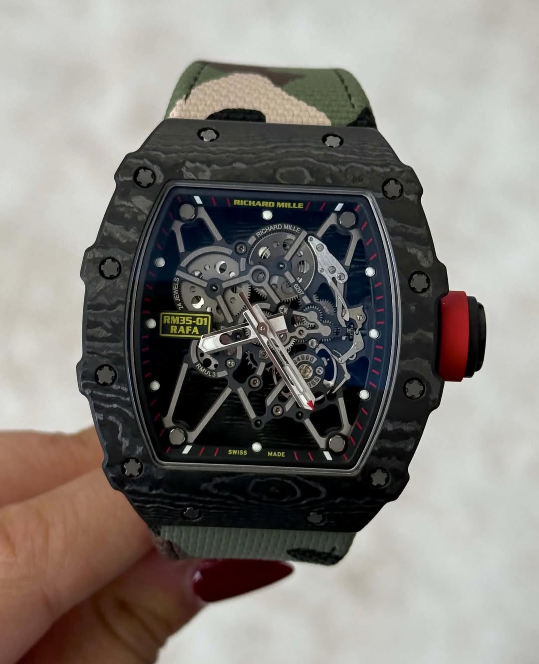 May be an image of wrist watch and text that says 'RICHA RICHARDMIL RICHARDMILLE WIL ICHAROMILLE MILE M35-01 RAFA Pm SWISS MADE'