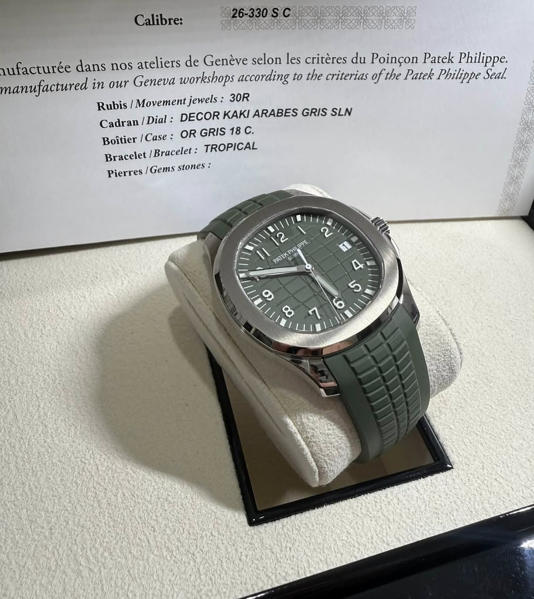 May be an image of wrist watch and text that says 'Calibre: 26-330 ufacturée dans nos ateliers de Genève selon les critères du Poinçon Patek Philippe. manufactured in our Geneva…