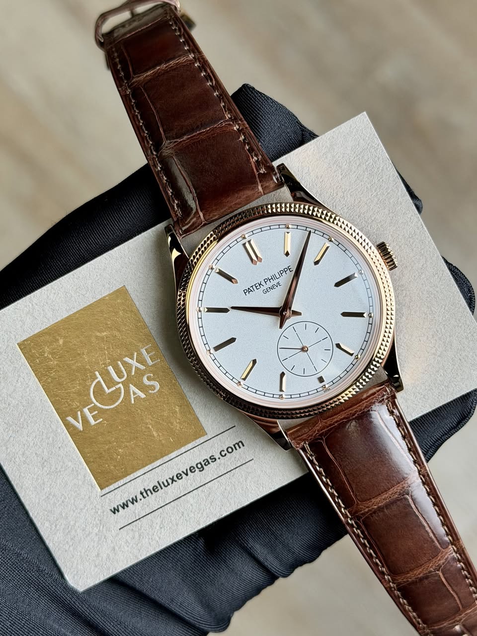 May be an image of leather, wrist watch and text that says 'แ I PATEK PHILIPPE IPPE GENEVE I 1 ١ νCυXE LUXE VEOAS AS