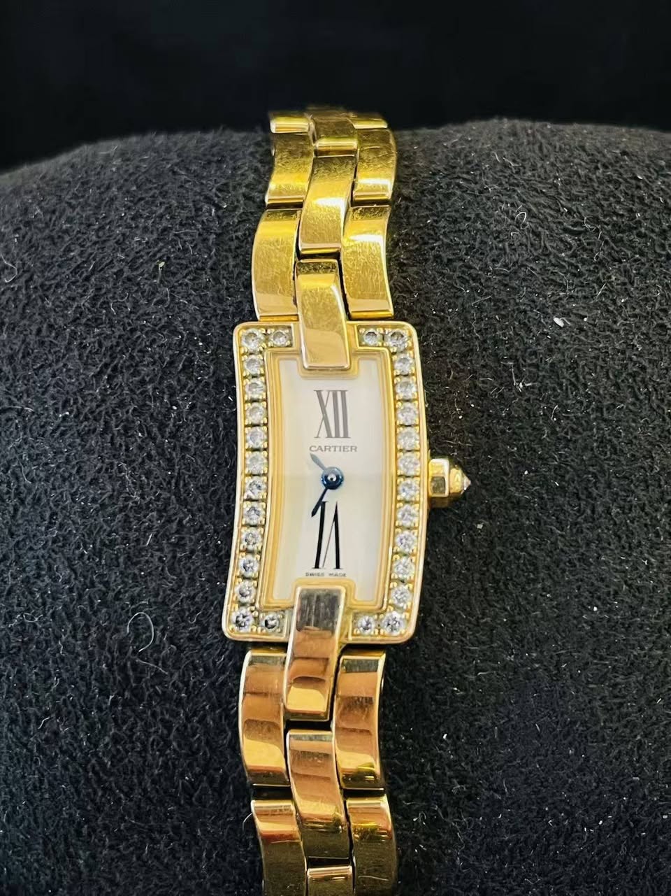 May be an image of jewelry, wrist watch and text that says 'XII CARTIER'