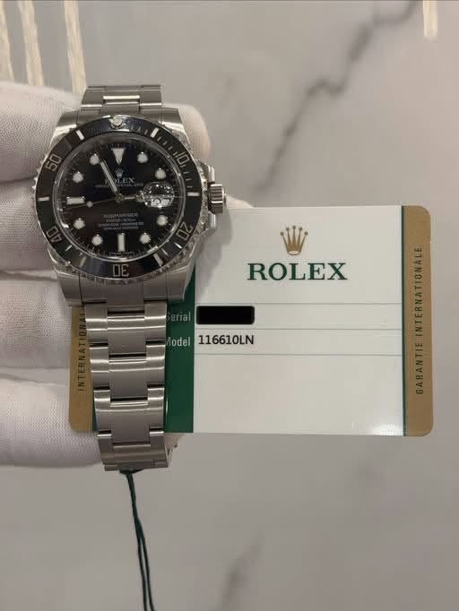 May be an image of wrist watch and text that says 'ROLEX odel 116610LN'