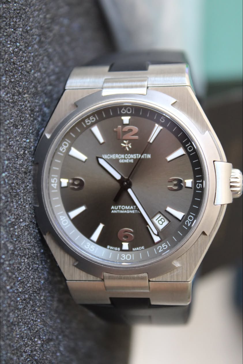 May be an image of wrist watch and text that says ' VACHERON VACHERONCONSTPNTIN CONSTA CONSTANTI NTIN GENEVE 10 45/ ١ I 15 AUTOMAT ANT ANTIMAGNET AUTOMAT SWISS MADE '