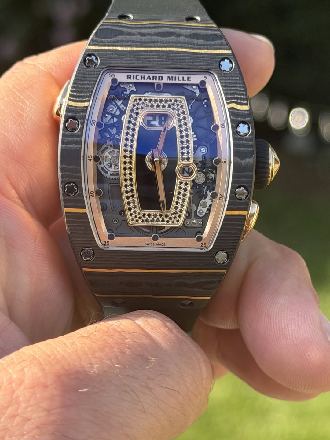 May be an image of wrist watch and text that says '55 RICHARD MILLE SWISS mSs MADE ក.្រា'