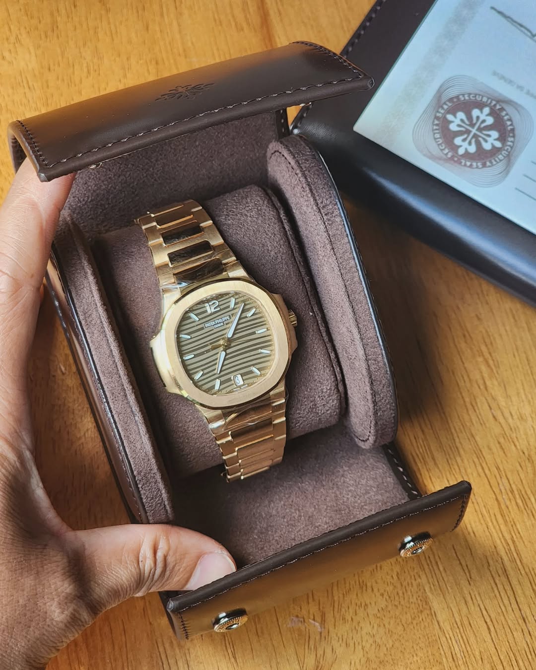 May be an image of saddle-stitched leather, leather, wrist watch and text